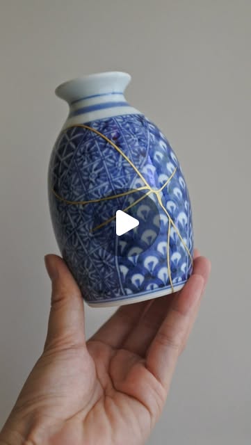 Kintsugi sake-bottle repair — urushi lacquer joins, gold powder finish